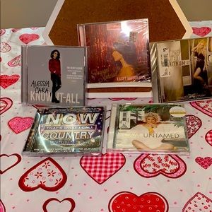 An assorted set of cd’s are still sealed except 1.